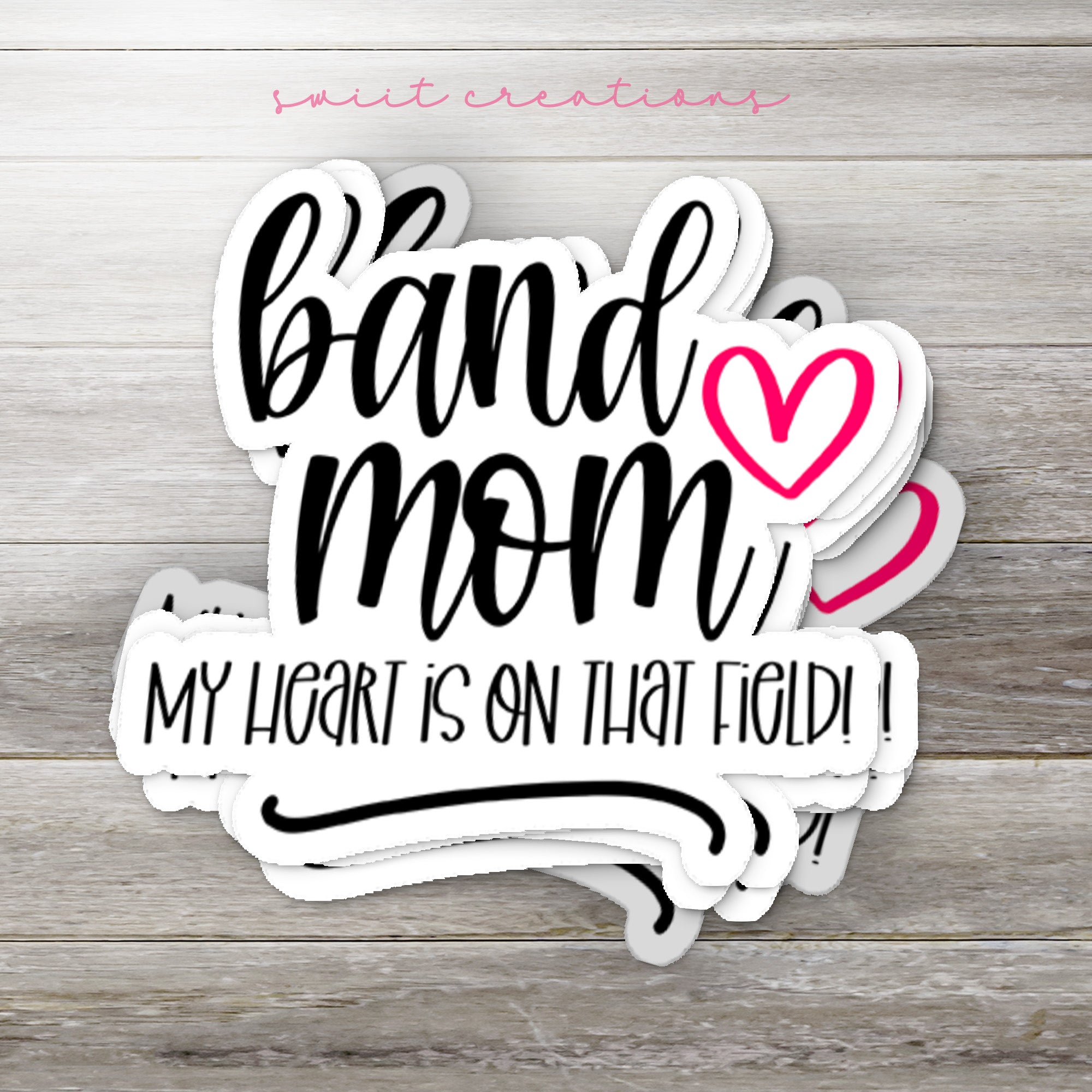 a sticker that says band mom my heart is on that hold