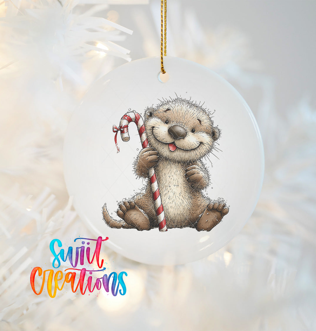 A white ornament featuring a smiling otter holding a candy cane.
