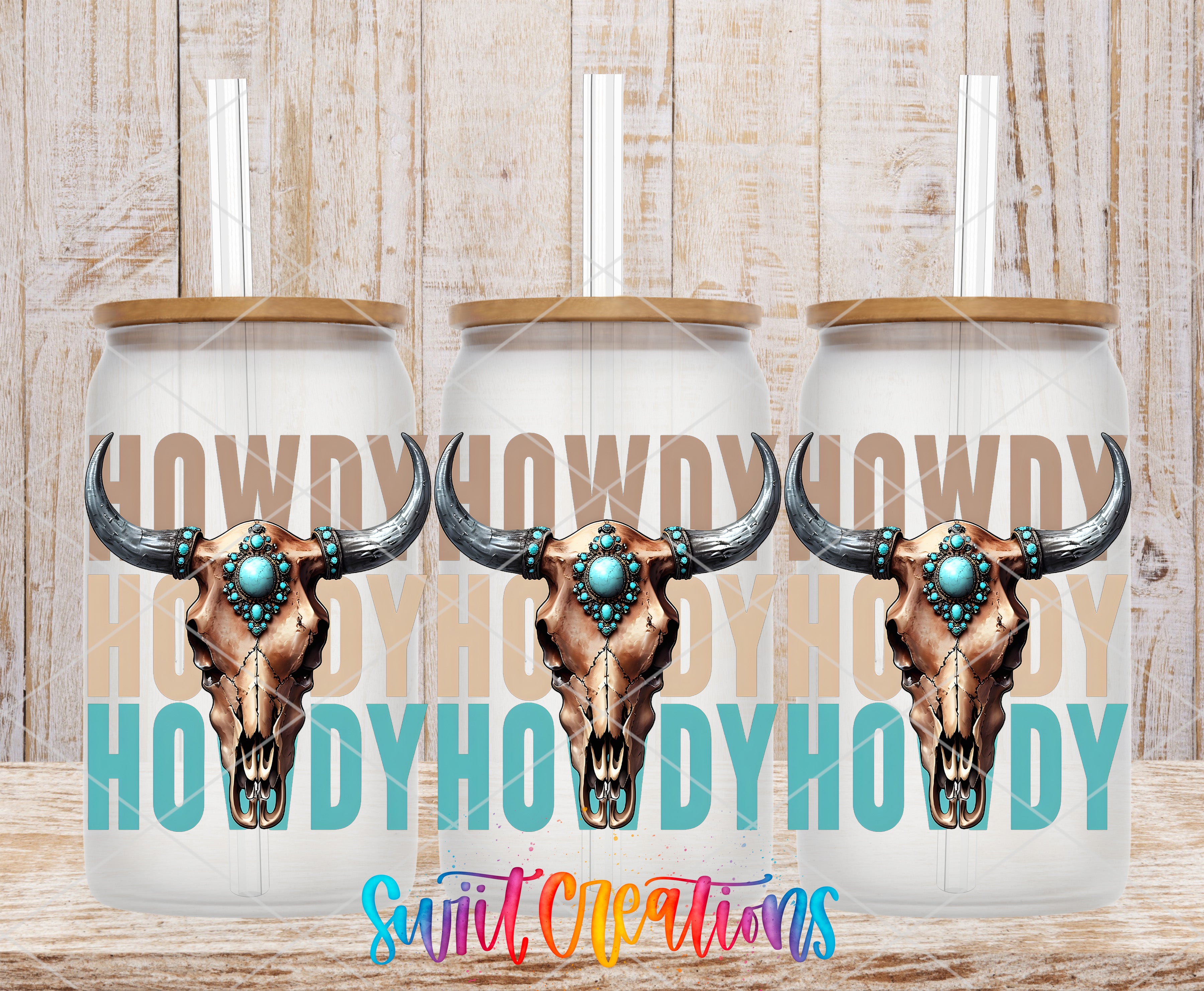 three clear glass tumblers with a cowboy skull design on the front, set against a wooden background.