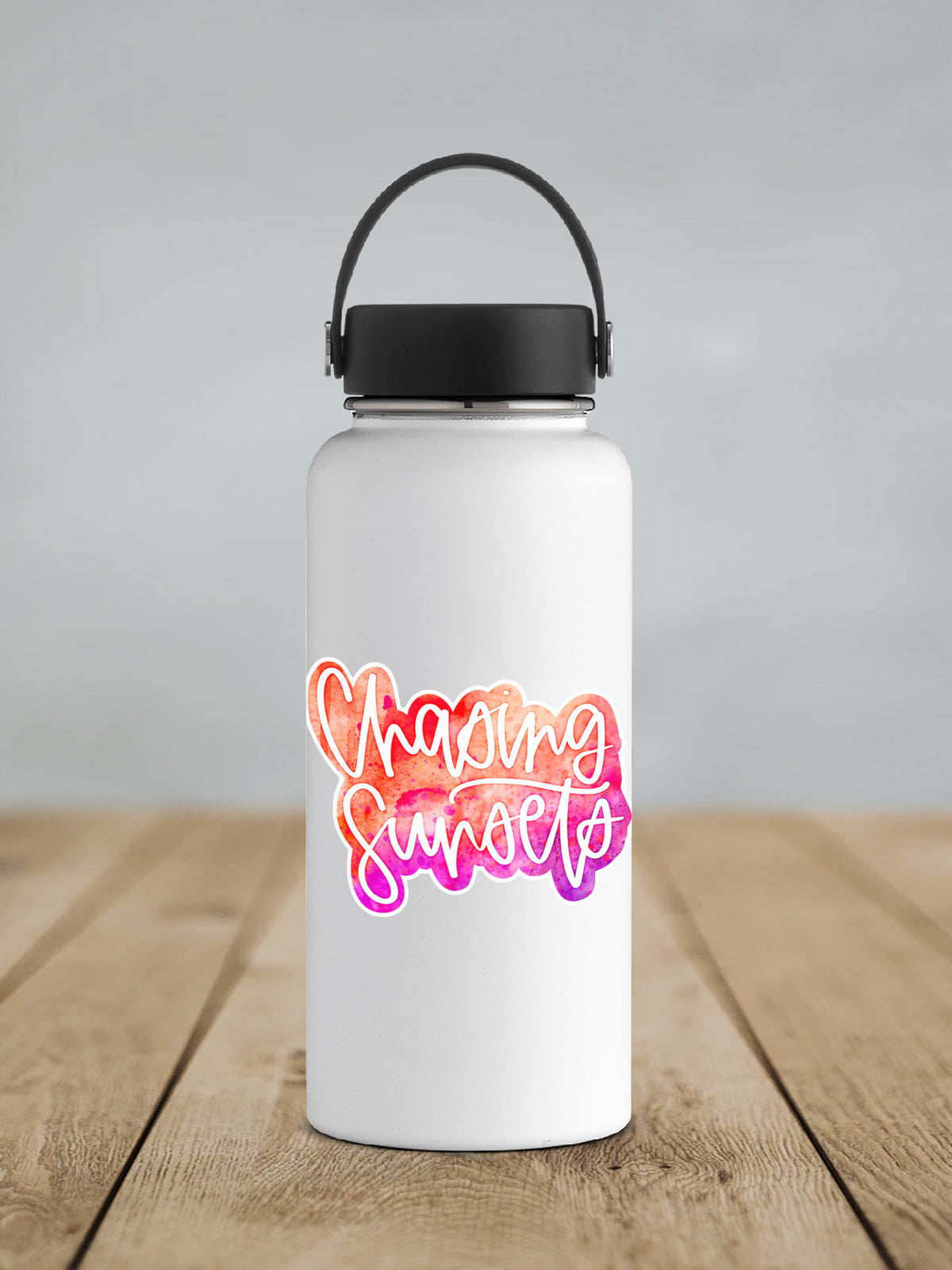Chasing Sunsets sticker on a white insulated water bottle