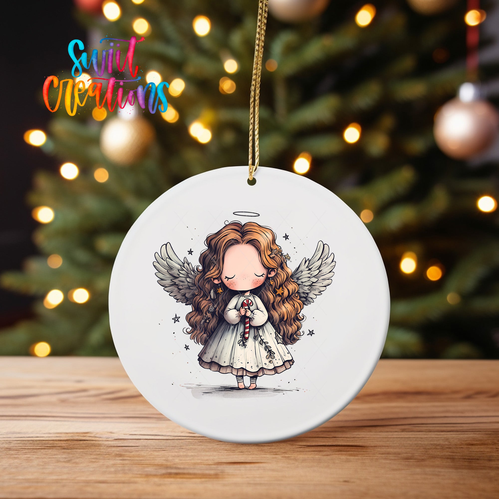 A white ceramic ornament featuring a cartoon illustration of a young girl with long curly hair and wings, holding a halo and a candy cane, standing in front of a Christmas tree with twinkling lights.