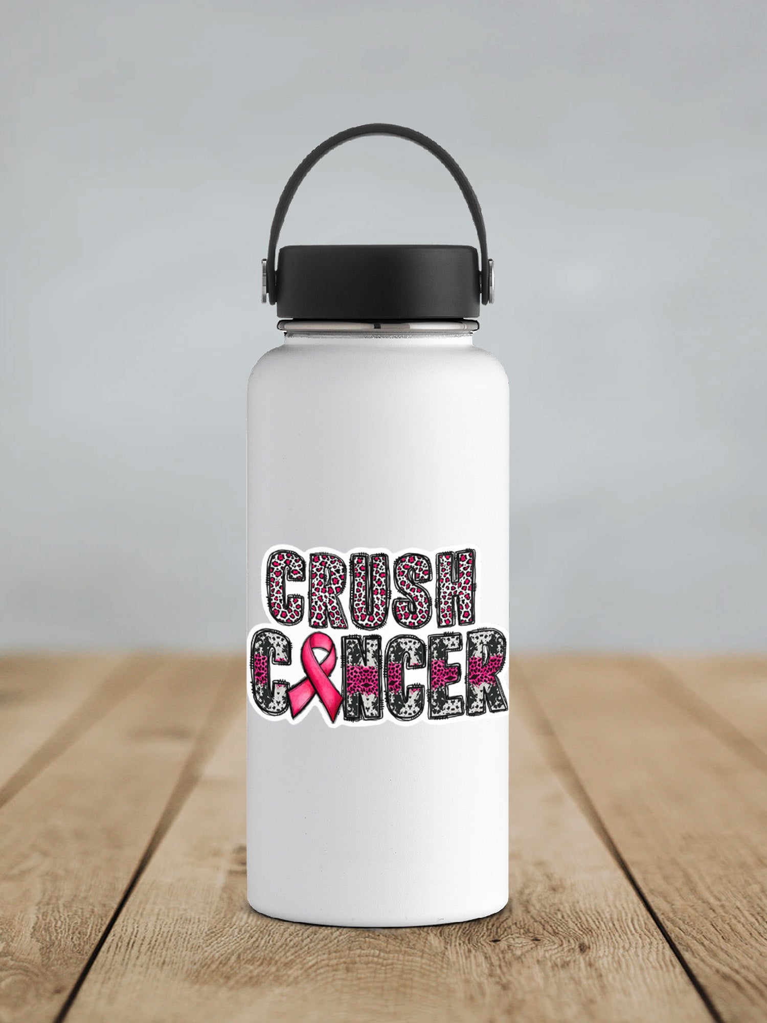 a white water bottle with a pink ribbon on it