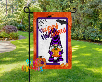 A Halloween-themed garden flag featuring a gnome holding a pumpkin and a spider web, with the text "Happy Halloween" displayed prominently.
