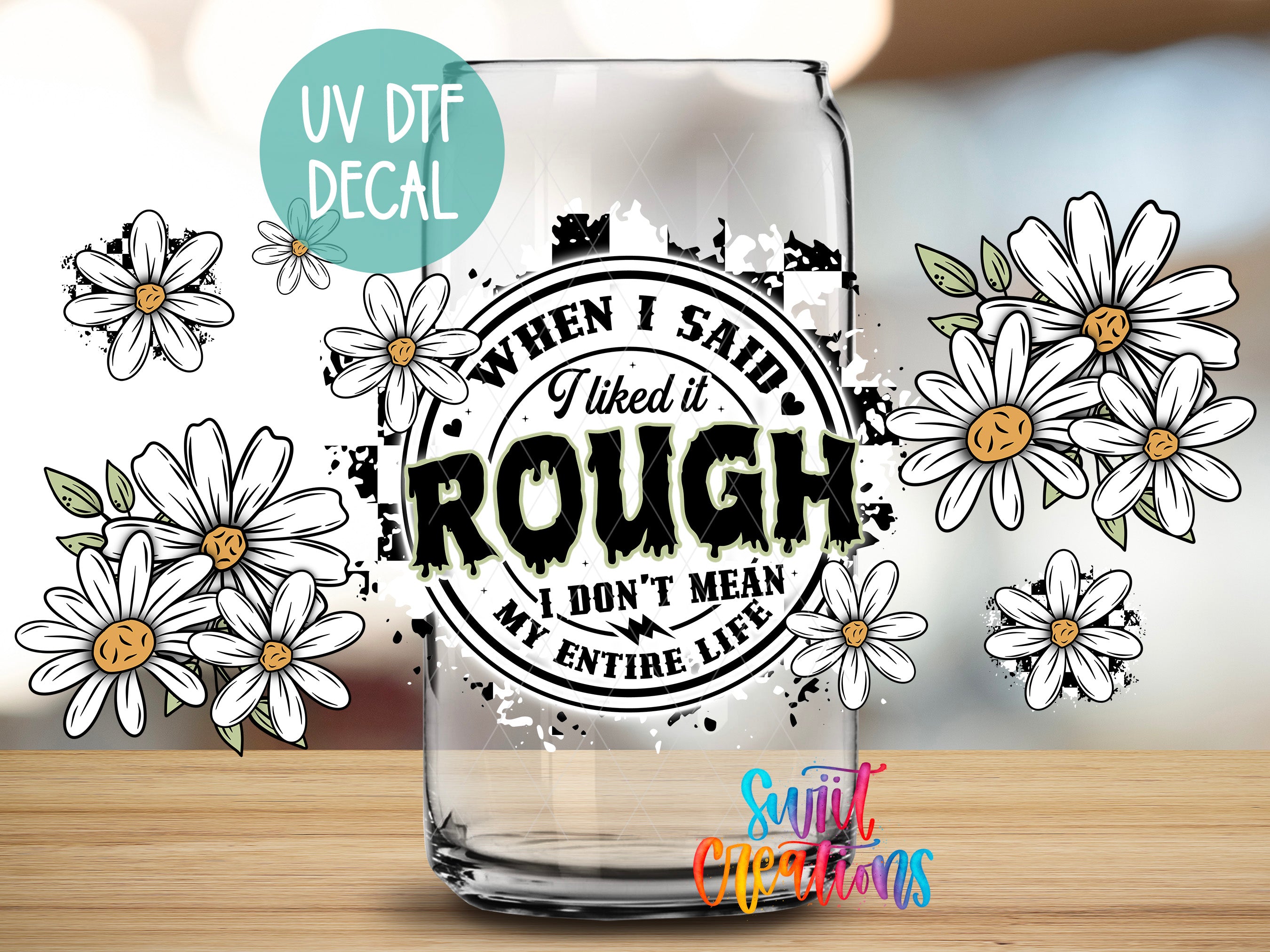 a glass with a sticker on it, surrounded by white flowers.