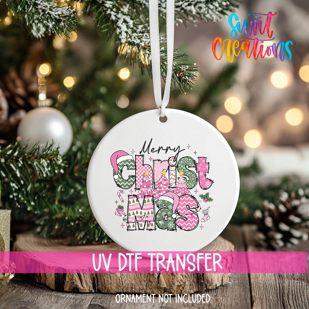 A white Christmas ornament with the text "Merry Christmas" and colorful decorative elements hangs on a tree branch.