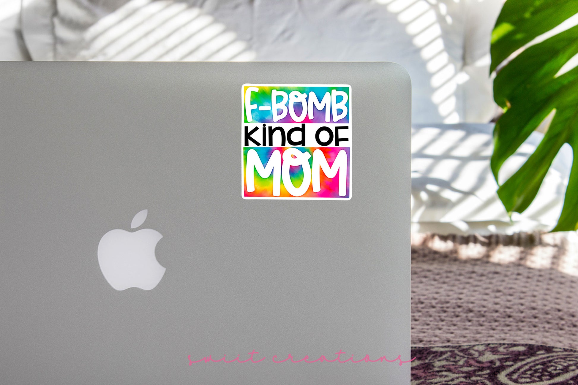 a laptop with a sticker that says bomb kind of mom