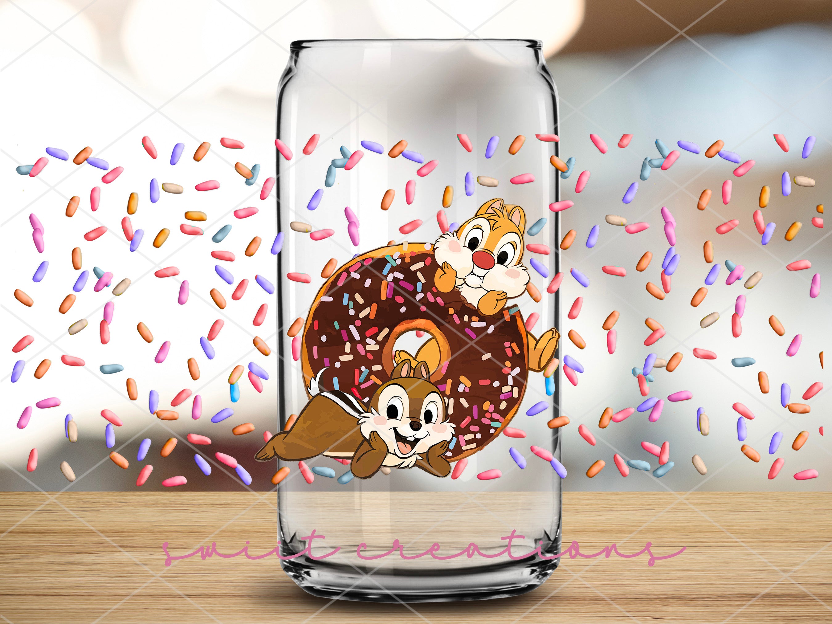 a glass with a picture of two chipmuns in a donut surrounded by
