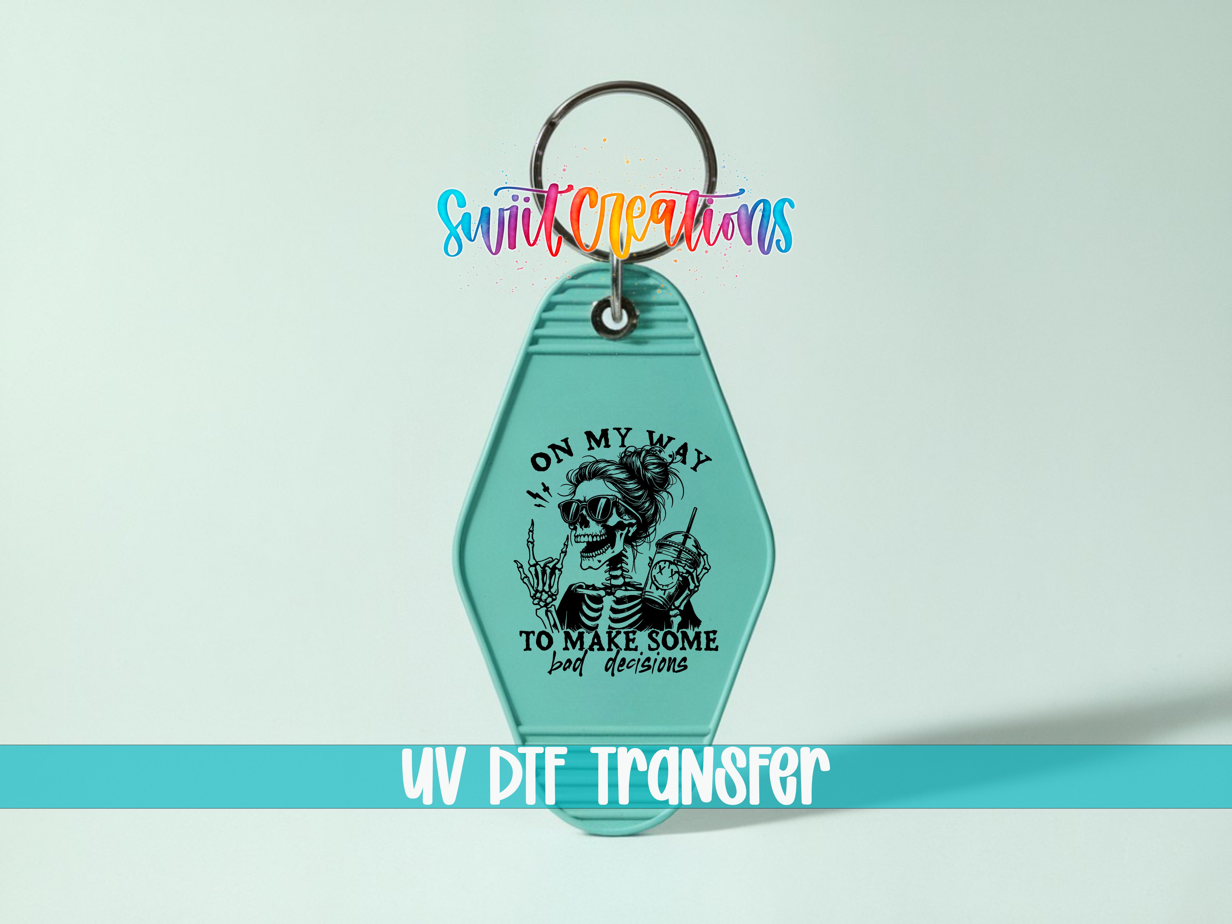 A keychain with a skull design and text that says "ON MY WAY TO MAKE SOME BAD DECISIONS" and "UV DIF TRANSFER".