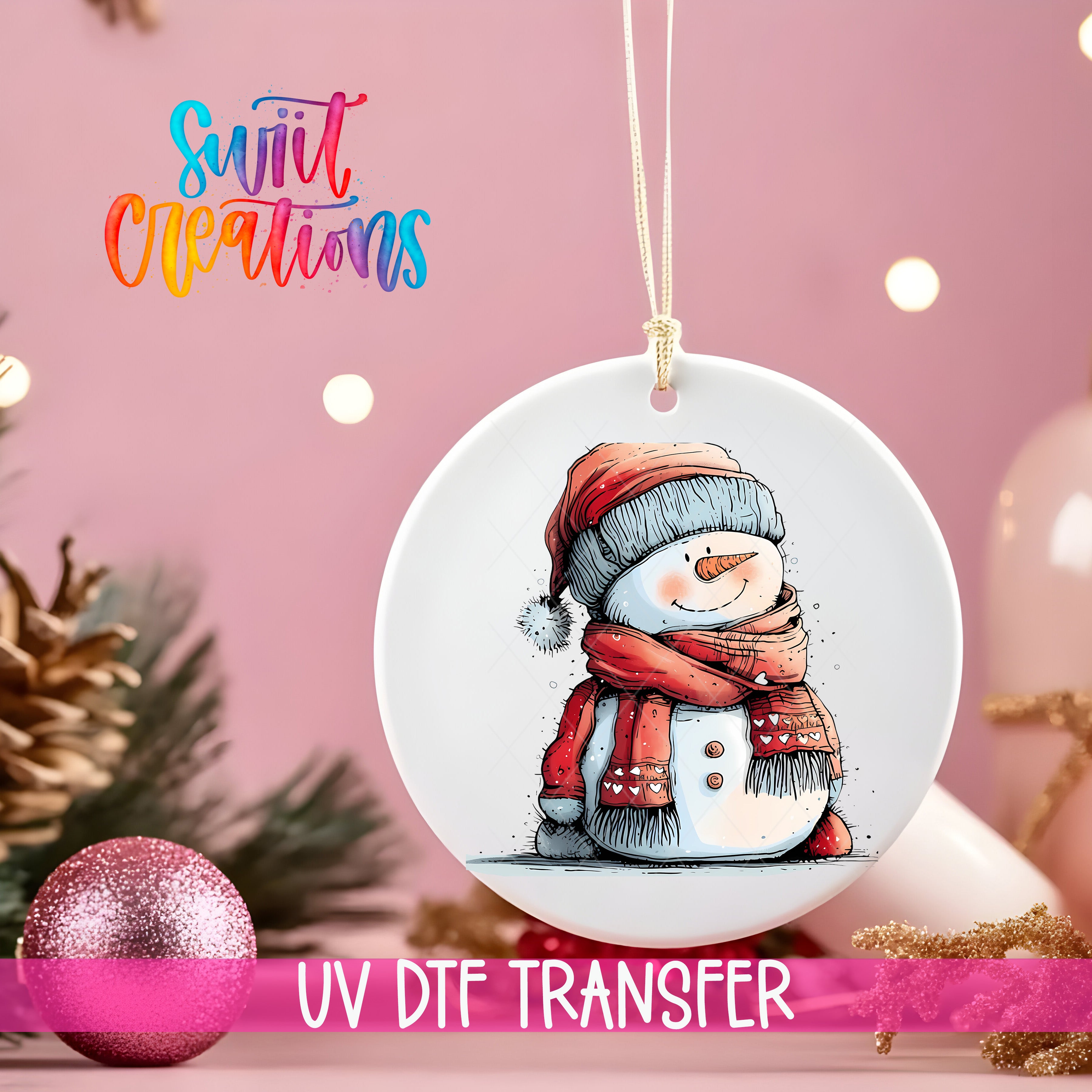 A white ceramic ornament with a snowman illustration is hanging on a string, surrounded by Christmas decorations and a pink background.
