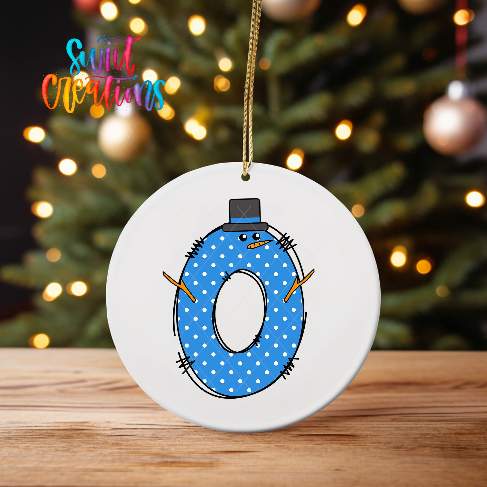 A white ornament with a blue polka dot design and a snowman figure hanging from a string.