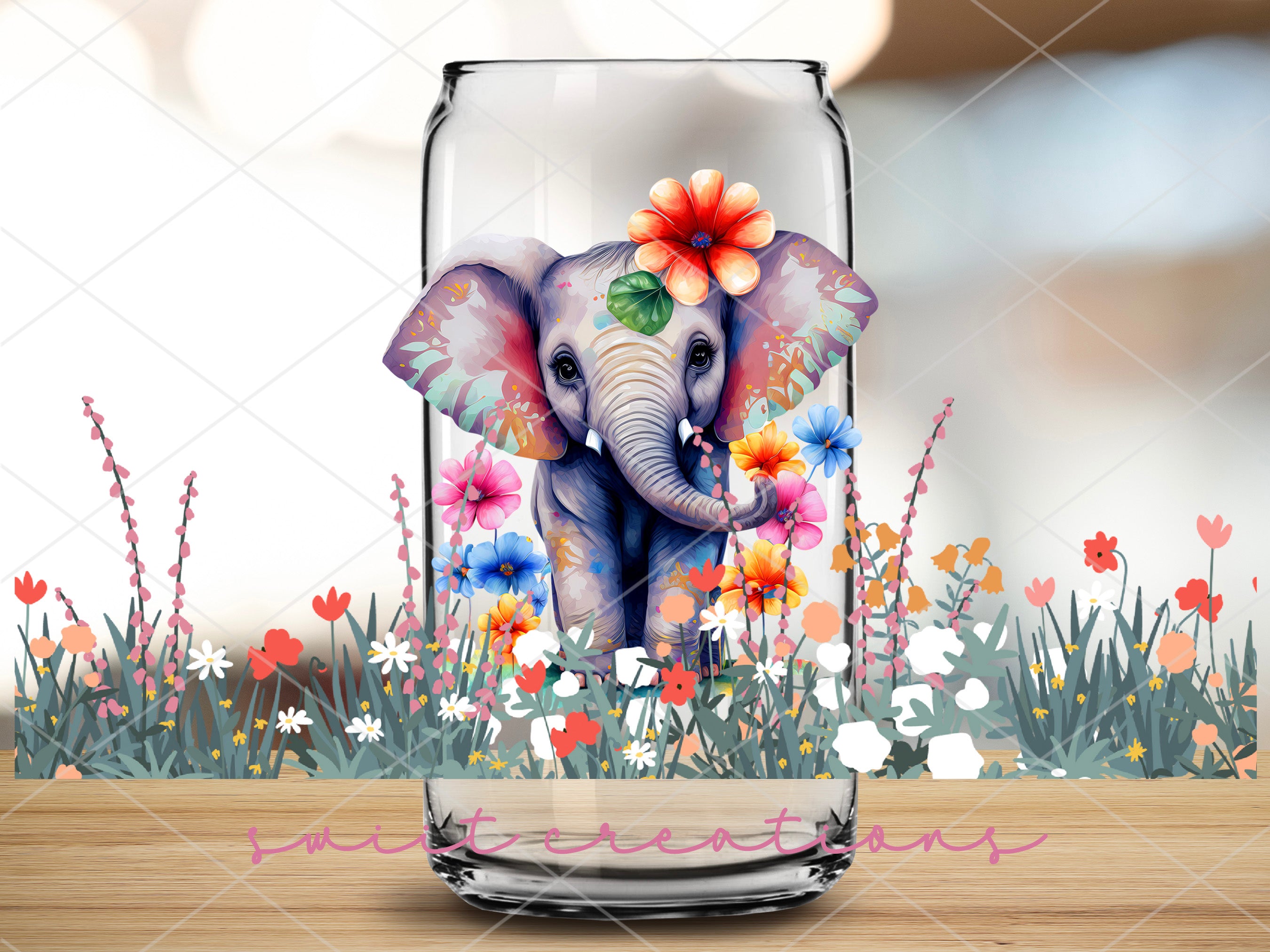 a glass jar with an elephant painted on it