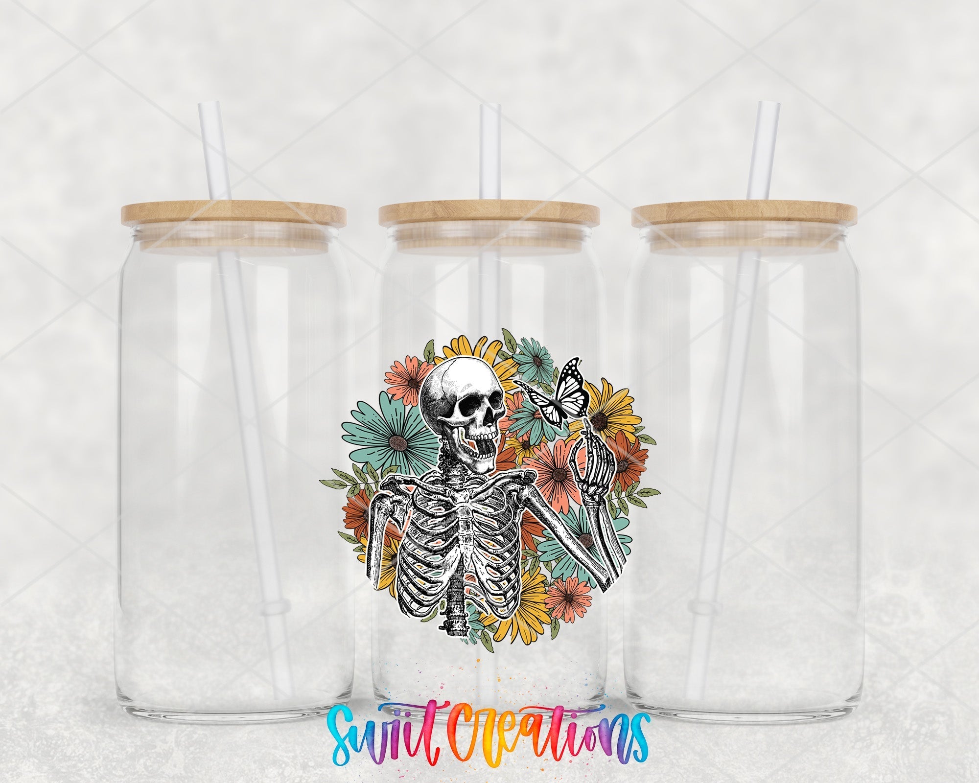 two clear tumblers with a skeleton and flowers on them