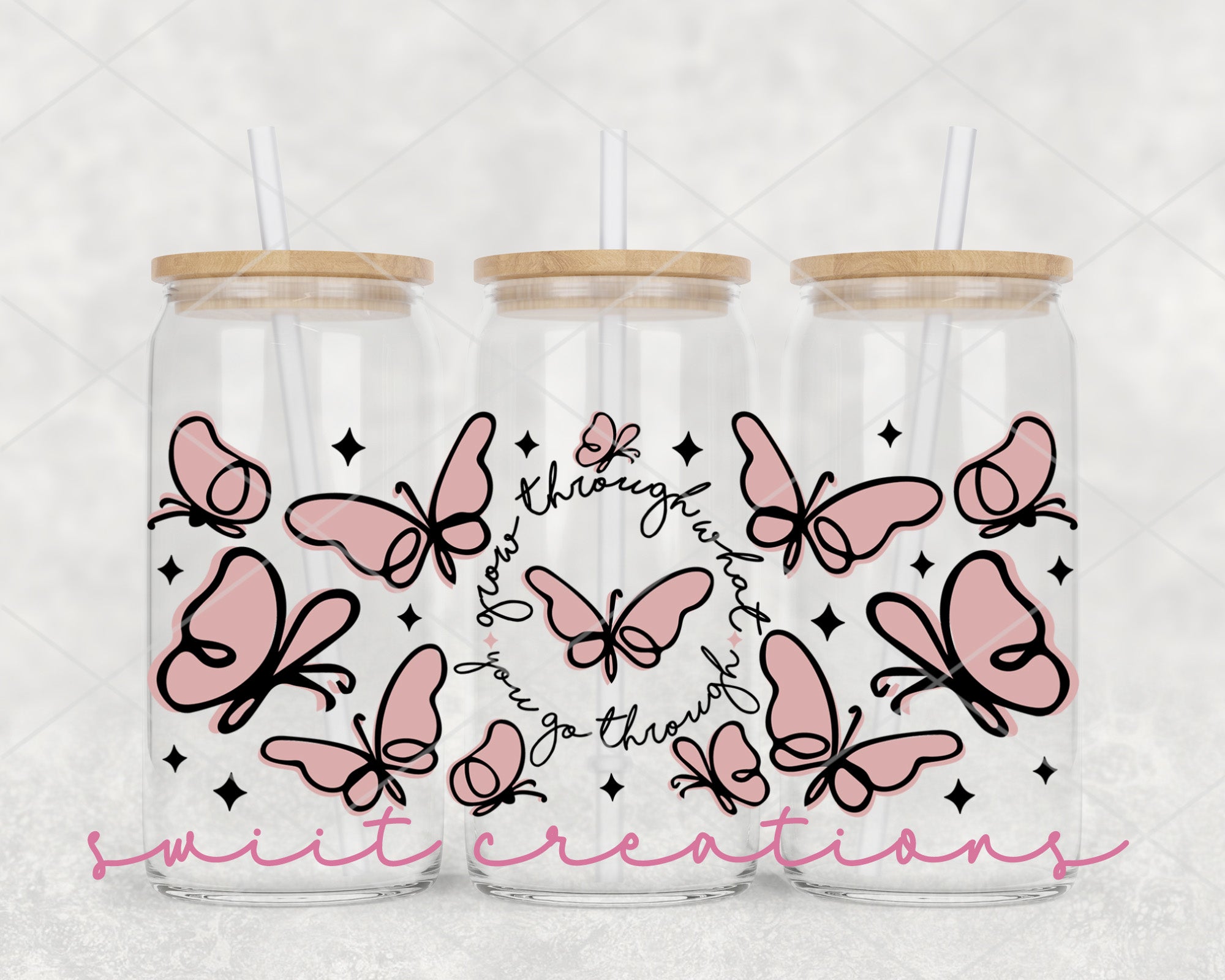 a couple of glass jars with pink butterflies on them