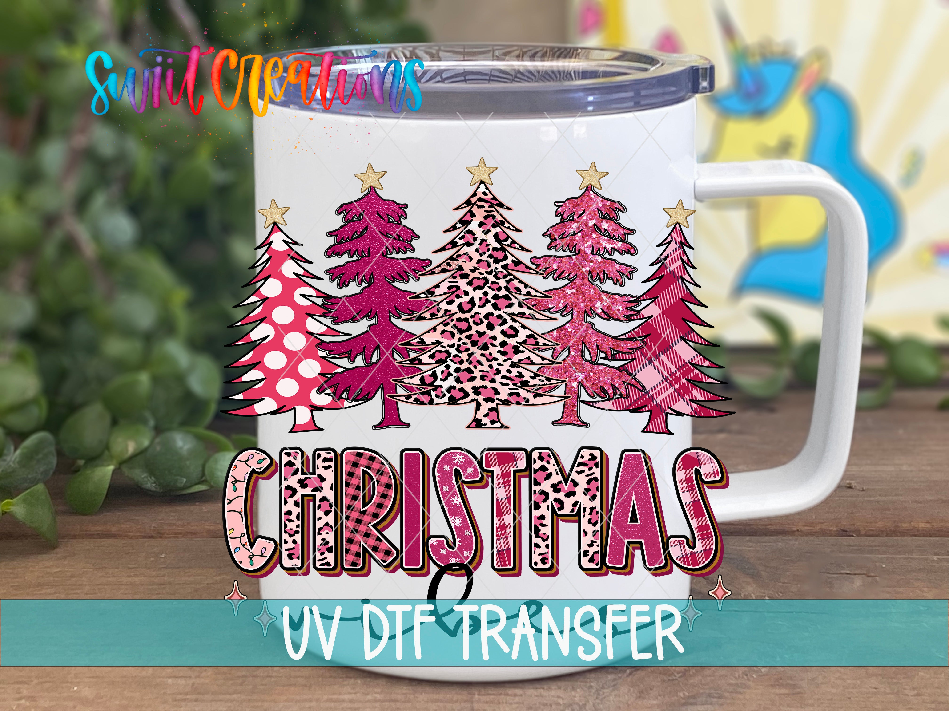 A white mug with a Christmas tree design and the word "Christmas" printed on it.