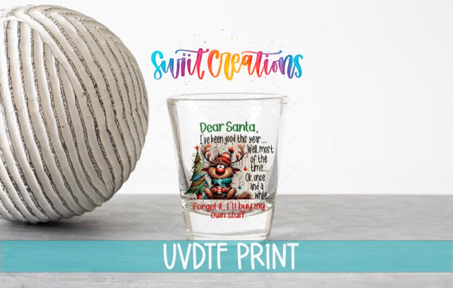 a shot glass next to a ball of yarn