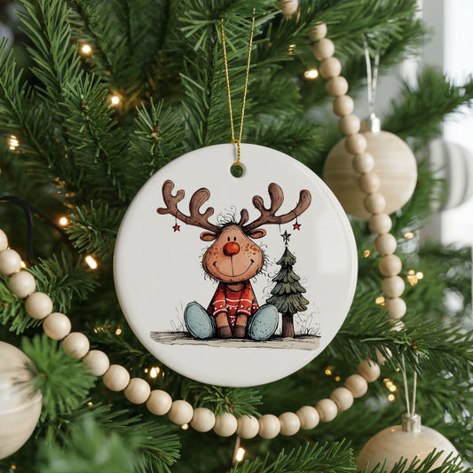 Sitting Reindeer with Gift and Christmas Tree ceramic Christmas ornament, front view