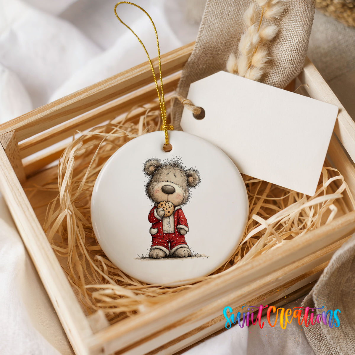 teddy bear holding a gingerbread cookie ceramic Christmas ornament displayed in a wooden gift crate