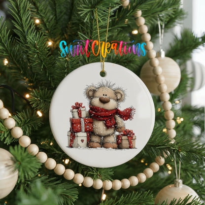 teddy bear with a red scarf and Christmas gifts ceramic Christmas ornament hanging on a green Christmas tree