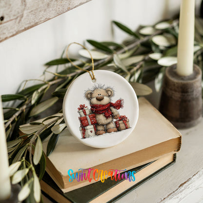 teddy bear with a red scarf and Christmas gifts ceramic Christmas ornament styled on stacked books with greenery