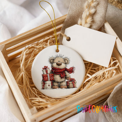 teddy bear with a red scarf and Christmas gifts ceramic Christmas ornament displayed in a wooden gift crate