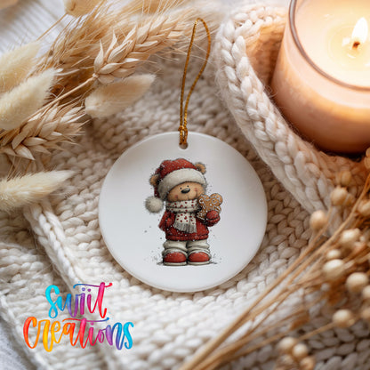 teddy bear in a Santa hat holding a gingerbread cookie ceramic Christmas ornament styled on a cozy knit blanket