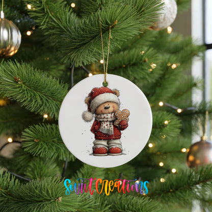 teddy bear in a Santa hat holding a gingerbread cookie ceramic Christmas ornament hanging on a lit Christmas tree