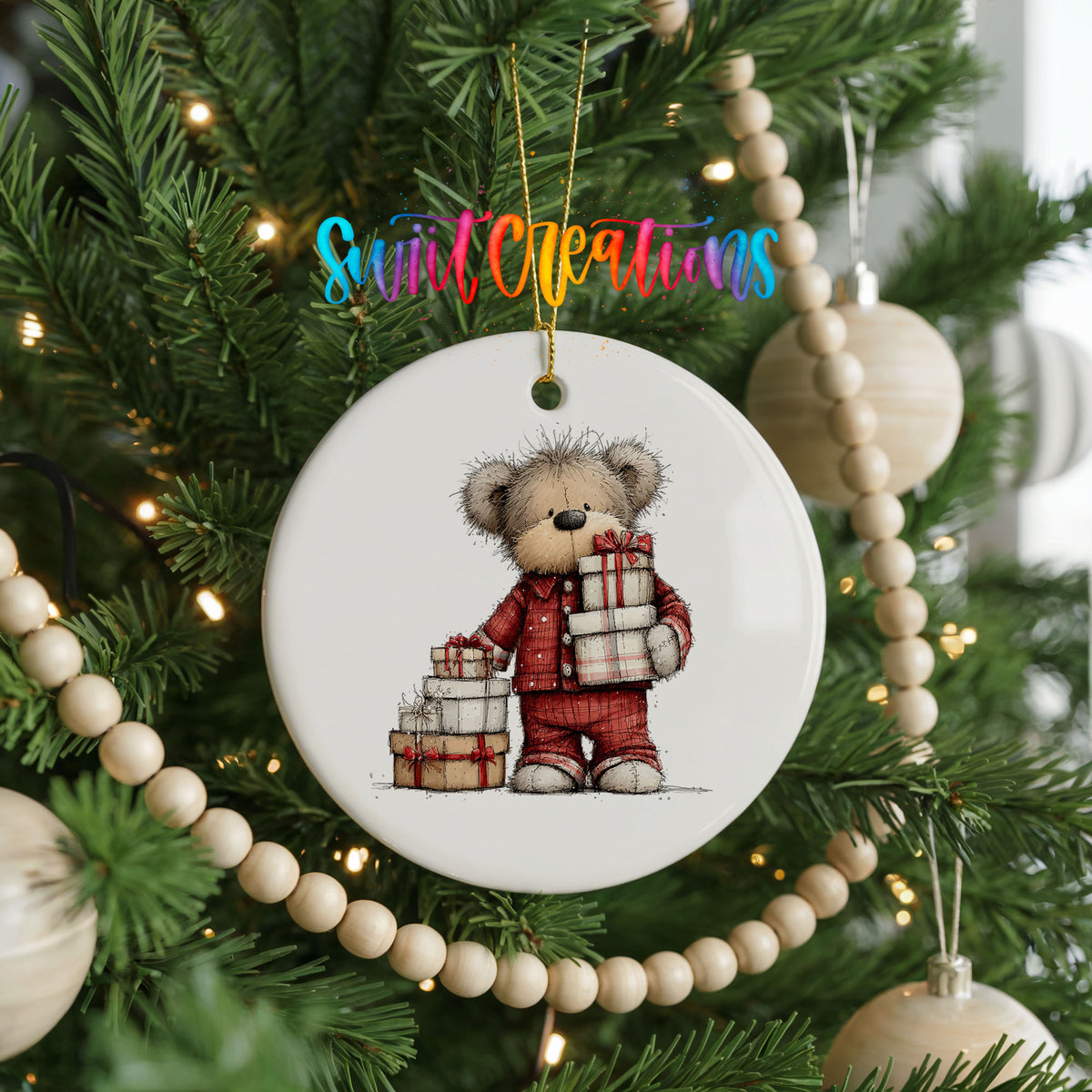 teddy bear carrying a stack of Christmas gifts ceramic Christmas ornament hanging on a green Christmas tree