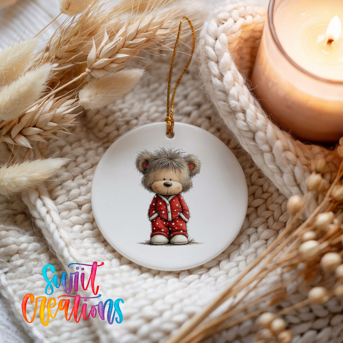 teddy bear wearing red Christmas pajamas ceramic Christmas ornament styled on a cozy knit blanket