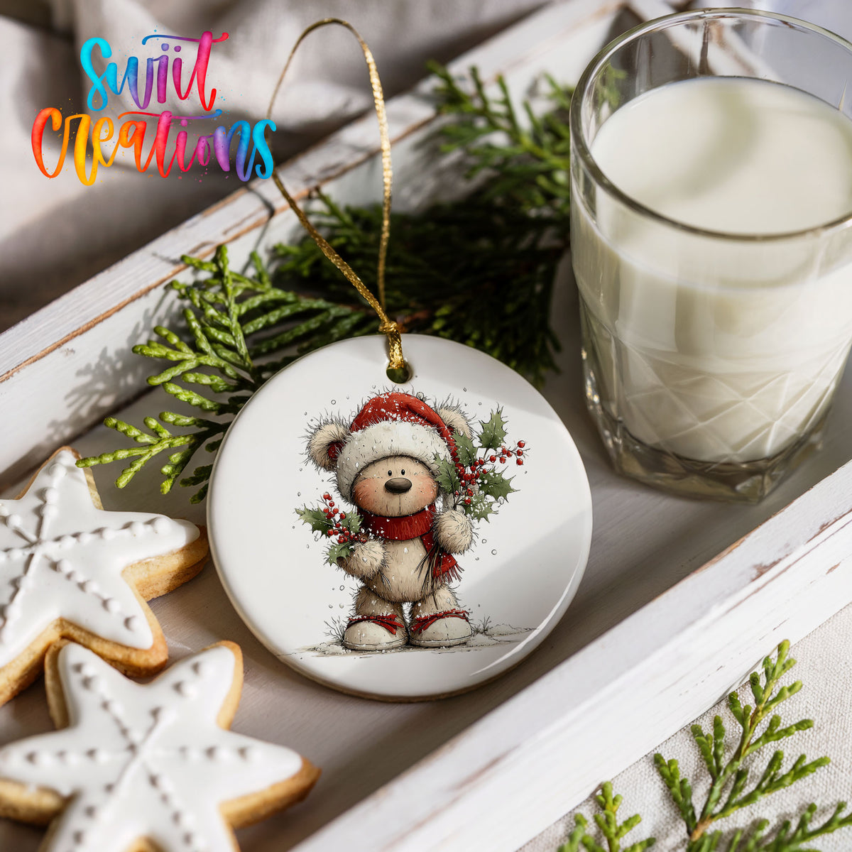 teddy bear framed by a Christmas wreath ceramic Christmas ornament styled with holiday cookies and a candle