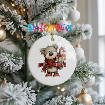 teddy bear in a red scarf carrying Christmas gifts ceramic Christmas ornament hanging on a frosted Christmas tree