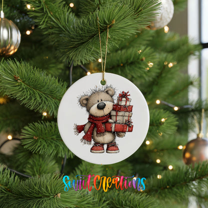teddy bear in a red scarf carrying Christmas gifts ceramic Christmas ornament hanging on a lit Christmas tree