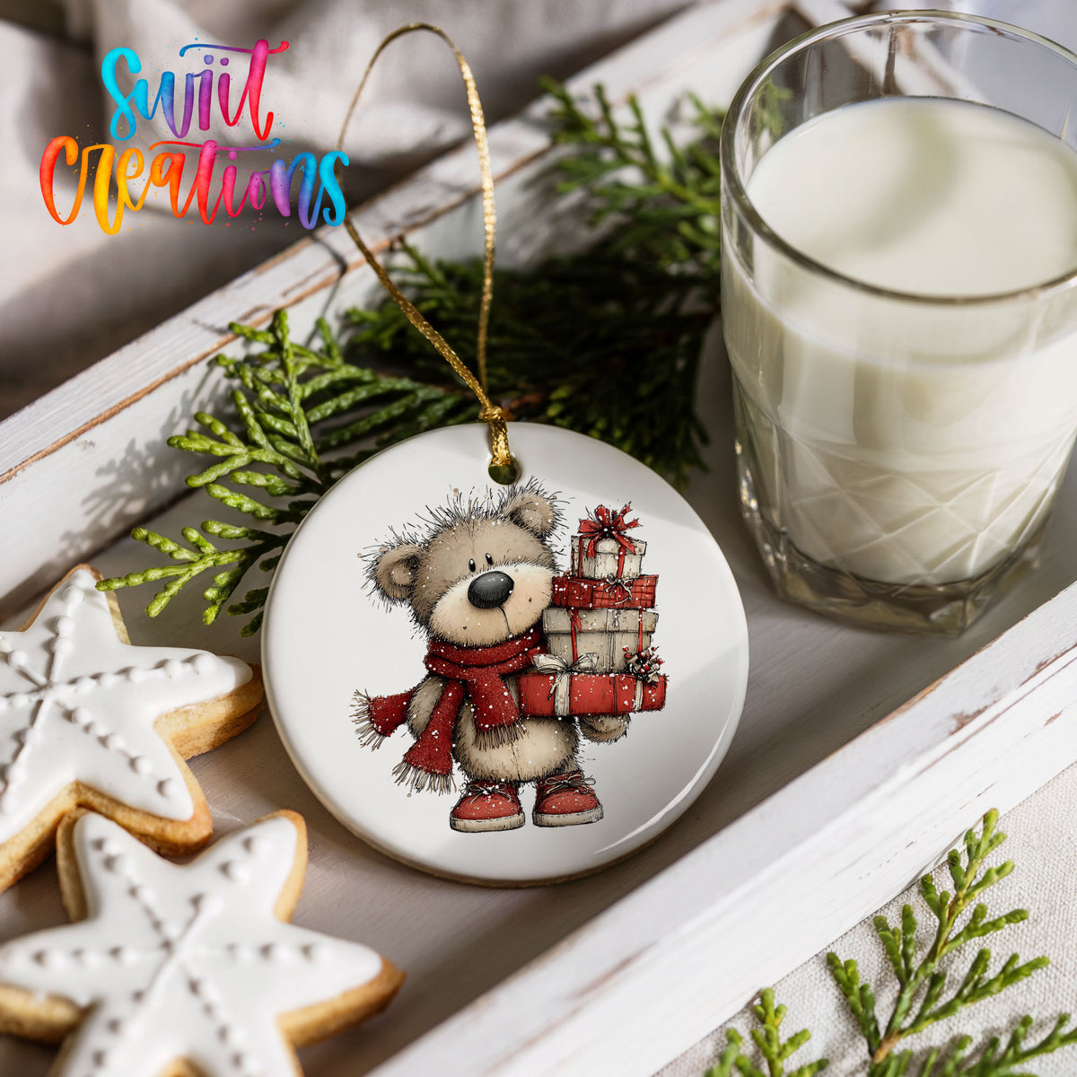 teddy bear in a red scarf carrying Christmas gifts ceramic Christmas ornament styled with holiday cookies and a candle