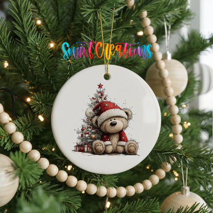 teddy bear sitting beside a decorated Christmas tree ceramic Christmas ornament hanging on a green Christmas tree