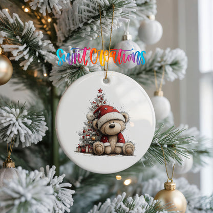 teddy bear sitting beside a decorated Christmas tree ceramic Christmas ornament hanging on a frosted Christmas tree