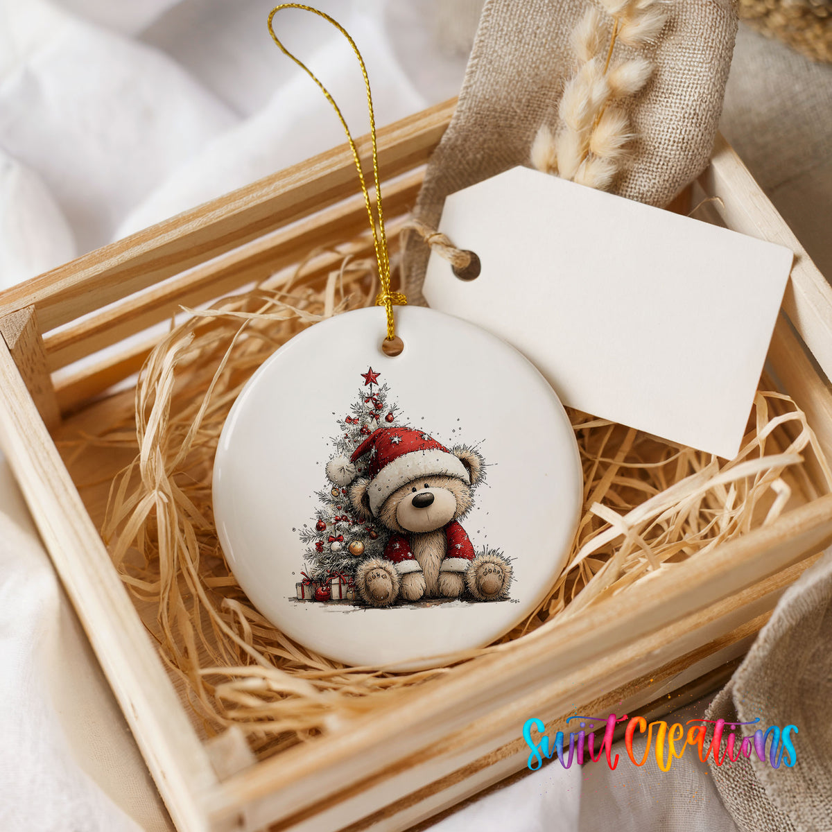 teddy bear sitting beside a decorated Christmas tree ceramic Christmas ornament displayed in a wooden gift crate