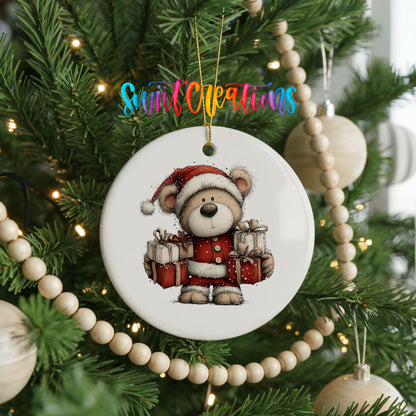 teddy bear dressed as Santa carrying Christmas gifts ceramic Christmas ornament hanging on a green Christmas tree