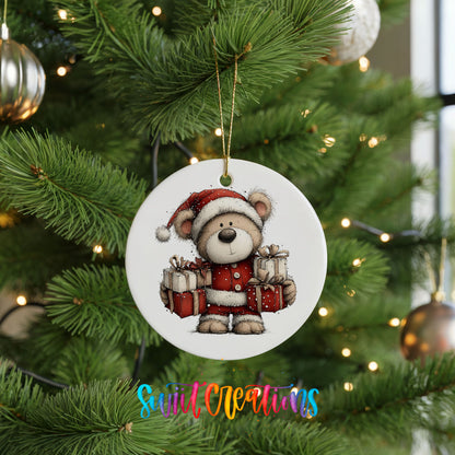 teddy bear dressed as Santa carrying Christmas gifts ceramic Christmas ornament hanging on a lit Christmas tree