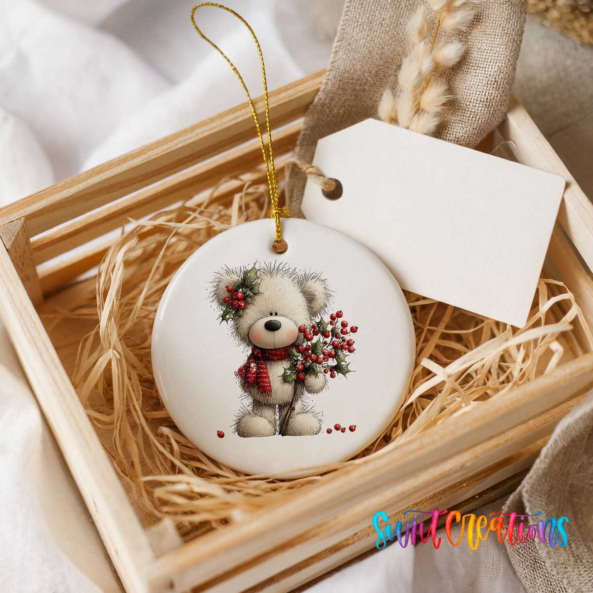 teddy bear with holly and red berries ceramic Christmas ornament displayed in a wooden gift crate