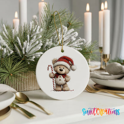 teddy bear wearing a Santa hat and holding a candy cane ceramic Christmas ornament shown in a holiday table setting