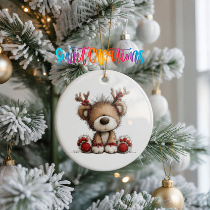 reindeer teddy bear with red Christmas ornaments ceramic Christmas ornament hanging on a frosted Christmas tree