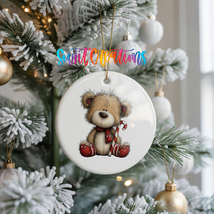 teddy bear with a candy cane and red Christmas ornament ceramic Christmas ornament hanging on a frosted Christmas tree