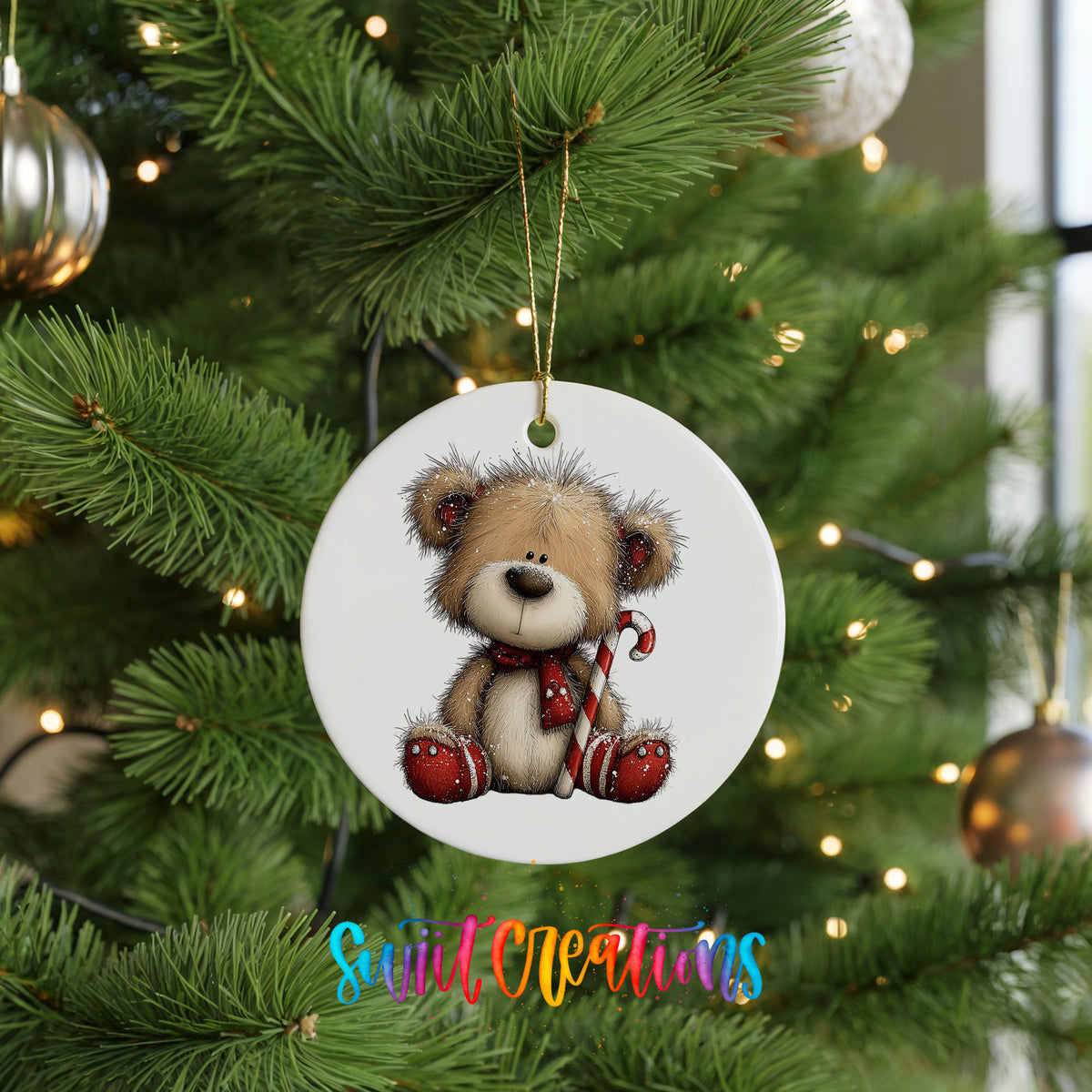 teddy bear with a candy cane and red Christmas ornament ceramic Christmas ornament hanging on a lit Christmas tree