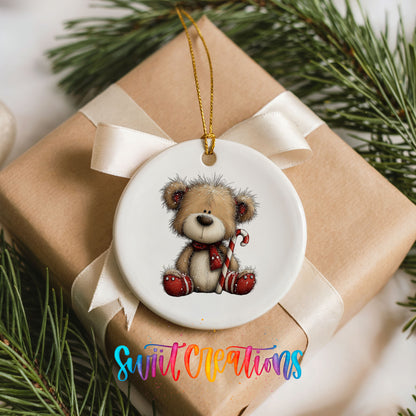 teddy bear with a candy cane and red Christmas ornament ceramic Christmas ornament displayed on a wrapped Christmas gift