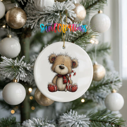 teddy bear with a candy cane and red Christmas ornament ceramic Christmas ornament hanging on a frosted tree with ornaments