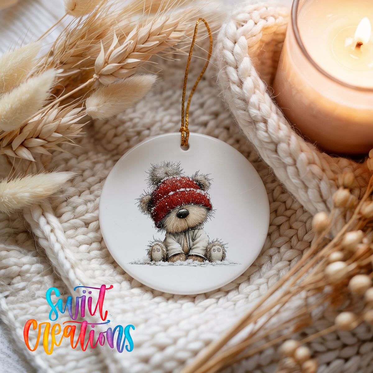 teddy bear in a red winter hat ceramic Christmas ornament styled on a cozy knit blanket