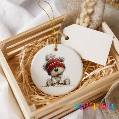 teddy bear in a red winter hat ceramic Christmas ornament displayed in a wooden gift crate