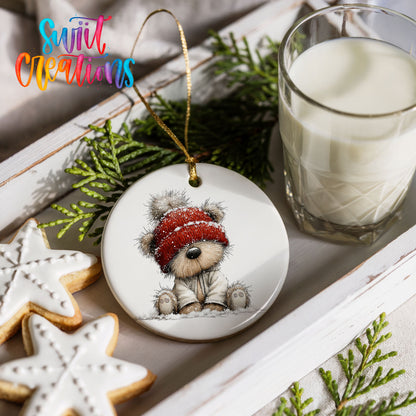 teddy bear in a red winter hat ceramic Christmas ornament styled with holiday cookies and a candle