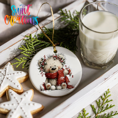 teddy bear with a red scarf and winter greenery ceramic Christmas ornament styled with holiday cookies and a candle