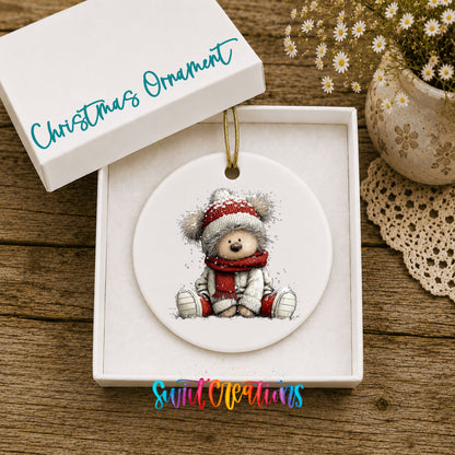 seated teddy bear in a red hat and scarf ceramic Christmas ornament presented in a gift box