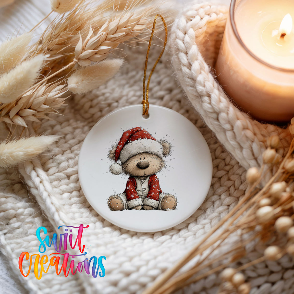 teddy bear in a Santa hat and red coat ceramic Christmas ornament styled on a cozy knit blanket